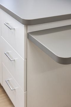 This image of the rounded counter detail at Core Dermatology shows a rounded counter edge, white drawers, cabinet pulls, and clean modern millwork.