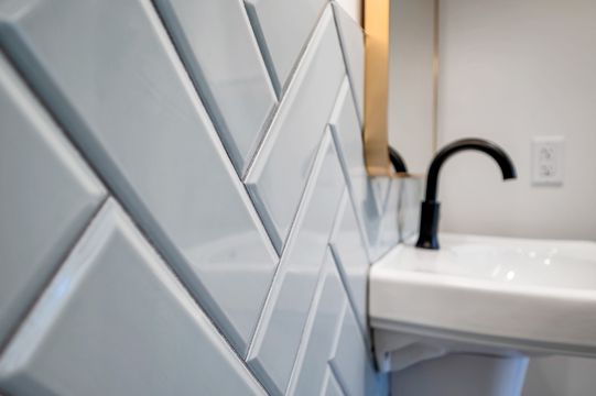 A close-up detail of the geometric tile backsplash and sink area inside Foundations Orthodontics, showing the office’s modern interior finishes.