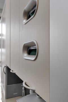 A close-up of Bridge Creek Dentistry clinical glove storage integrated into white operatory cabinetry, highlighting clean organization and modern treatment room design.