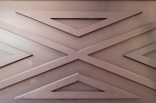 Detailed close-up of the dimensional geometric accent wall used throughout the Foundations Orthodontics interior.